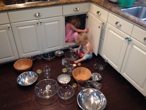My daughters organizing the kitchen cabinet