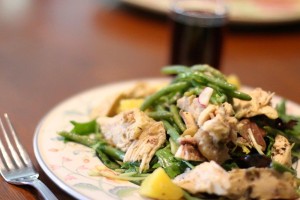 Roast chicken atop salad